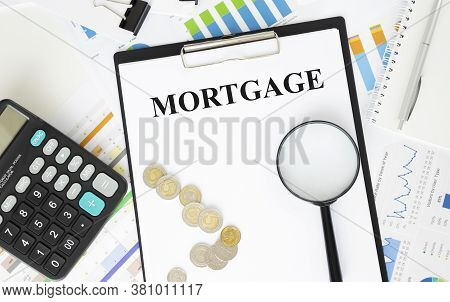 Paper With Text Mortgage On A Financial Tables With Glasses. Business And Financial Conzept
