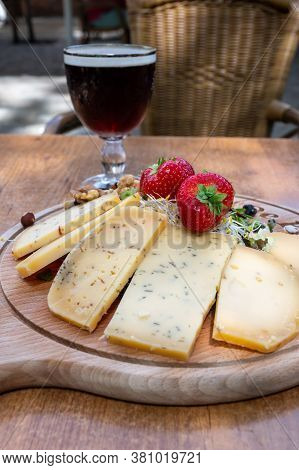Tasting Of Different Belgian Cheeses And Dark Strong Belgian Beer Served Outdoor Close Up