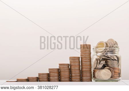 Saving Money, Coin In Glass Bottle With Money Stack. Financial Business Investment Concept.