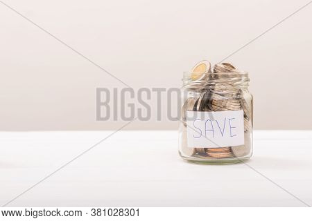 Coin In Glass Bottle. Save Coin In Jar Isolated On White Or Gray Background. Business Concept.