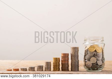 Coin Stack , Coin In Glass Bottle. Save Coin In Jar Isolated On White Or Gray Background. Business C