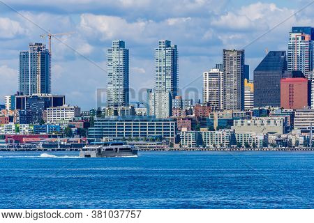 A Water Taxi Cruises Toware The Skyline In Seattle, Washington.