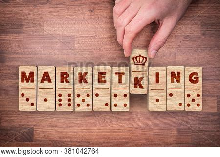 Marketing Successful Guru Concept. Hand With Dominoes Pieces And Text Marketing And Pun With Word Ki