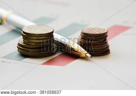 Pen And Calculator On A Financial Graphic. Financing. High Quality Photo