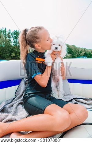 Little Girl Sailing On Boat In Clear Open Sea