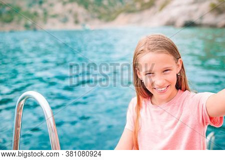 Little Girl Sailing On Boat In Clear Open Sea