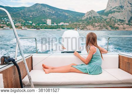 Little Girl Sailing On Boat In Clear Open Sea