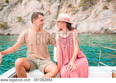 Coupl On Honeymoon Sailing On Boat In Clear Open Sea