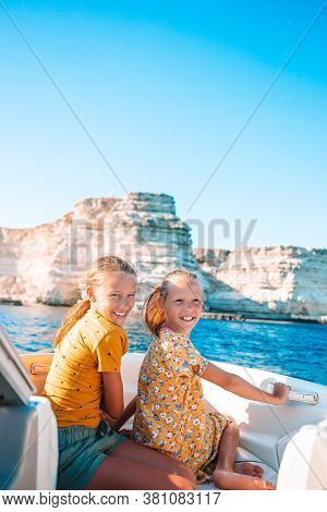 Little Girls Sailing On Boat In Clear Open Sea