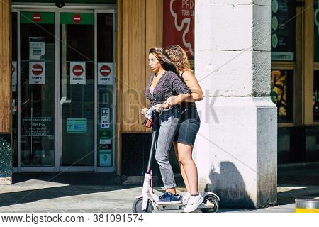 Reims France August 15, 2020 View Of Unidentified People Rolling With An Electric Scooter In The Str