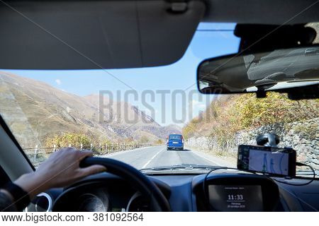 Tbilisi, Georgia - October 25, 2019: Car Vindow, Hand Of Woman On Steering Wheel And View To The Roa