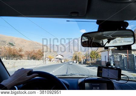 Tbilisi, Georgia - October 25, 2019: Car Vindow, Hand Of Woman On Steering Wheel And View To The Roa