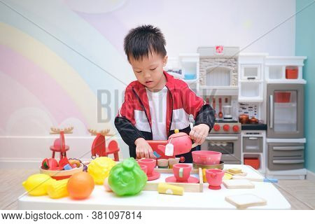 Cute Little Asian 3 -4 Years Old Toddler Boy Child Having Fun Playing Alone With Cooking Toys, Kitch
