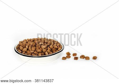 Dry Pet Food In A White Ceramic Bowl Isolated On White Background. Copy Space
