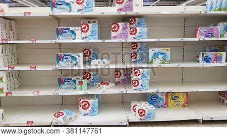 Half Empty Shelves With Toilet Paper Due To Coronovirus In A Supermarket