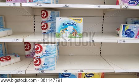 Half Empty Shelves With Toilet Paper Due To Coronovirus In A Supermarket