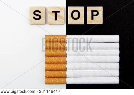 Close-up Of Cigarettes And Wooden Blocks, Showing The Safe Word On A White, Black Background. World 