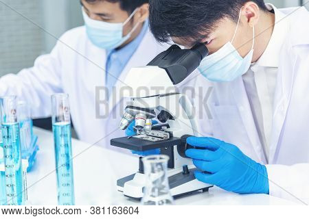 Two Asian Scientist Team Reserch Chemistry Science Tube Experiment Biotech Antibody Sample In Labora