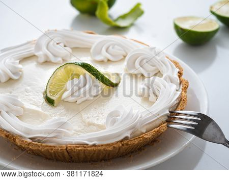 Keylime Pie And Fresh Limes On A White Table.