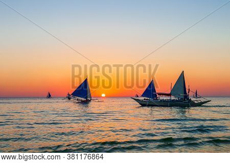 Traditional Filipino Boat At The Idyllic White Sand Beach At Boracay Island In Philiphines
