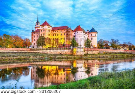 Picturesque Morning View Of Hartenfels Castle On Banks Of The Elbe. Dramatic Sunrise. Location: Torg