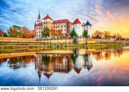 Picturesque Morning View Of Hartenfels Castle On Banks Of The Elbe. Dramatic Sunrise. Location: Torg