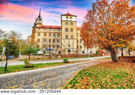 Astonishing Autumn View Of Hartenfels Castle On Banks Of The Elbe. Picturesque View Of Torgau Town. 