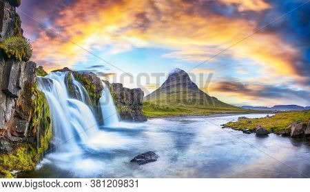 Dramatic View On Kirkjufellsfoss Waterfall  Near Kirkjufell Mountain At Sunset.  Location: Kirkjufel