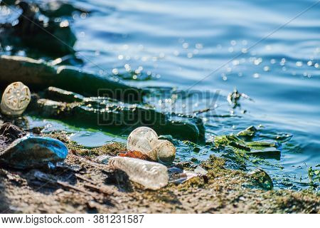 Environmental Water Pollution. Polluted River - Dirty Green Water, Garbage, Waste And Trash. Harmful