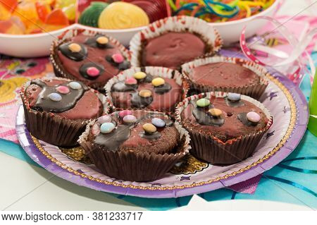 Chocolate Muffin Cup Cakes On A Plate At Childs Birthday Party.
