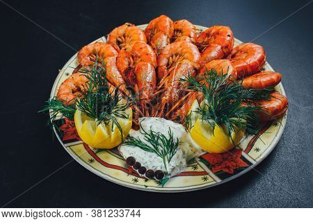 Shrimps With Lemon And Black Pepper On Dark Background