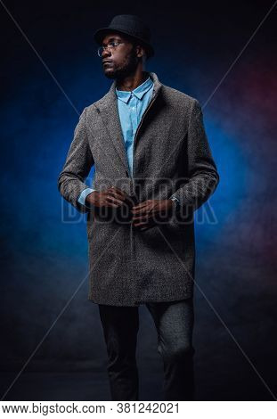 Blue Background And Black Rich Dressed Person In The Foreground. Fashoinable Quality Glam Dress. Afr