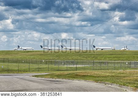 Horizontal Shot Of Passenger Jet Aircraft Lined Up Waiting On Takeoff Permission.