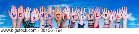Children Hands Building Word Weihnachtsferien Means Christmas Break, Blue Sky