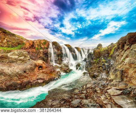 Dramatic View Of  Kolufossar Waterfall At Sunset.  Popular Tourist Travel Destination In Iceland . L