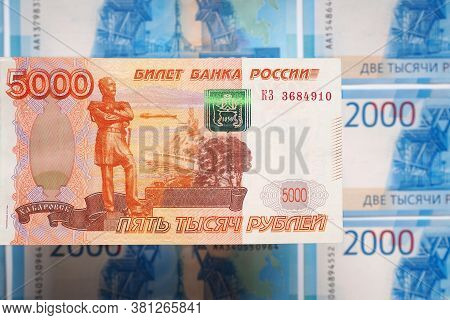 Russian Banknote 5000 Rubles Hanging Over The Field Of Banknotes 2000 Rubles. The View From Above. C