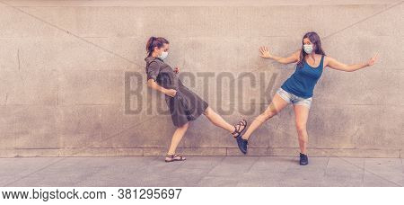 Happy Friends Keeping Social Distancing Greeting Each Other In The New Normal Coronavirus Style