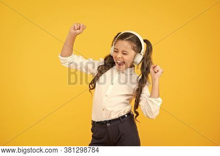 Singing In Tune. Cute Small Child Taking Her Singing Lessons On Yellow Background. Adorable Little G