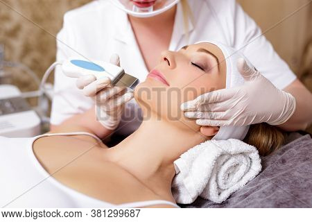 Cosmetology And Beauty Concept - Close Up Of Beautiful Woman Receiving Ultrasound Cavitation Facial 