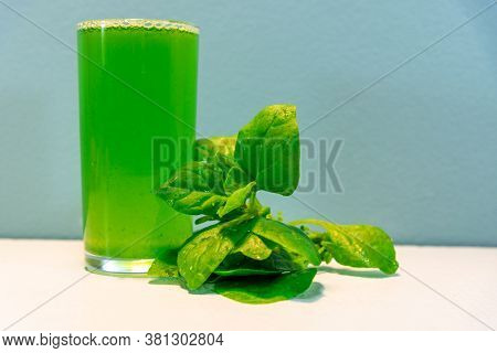 Spinach Juice (spinacia Oleracea) On Blue Background