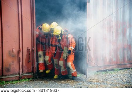 Firefighters Are Helping Workers By Pulling Out Of The Burning Building.