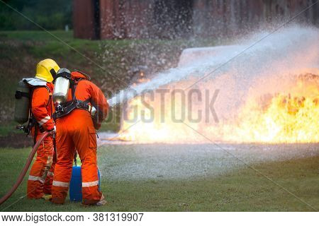 Firefighters Spraying Water To Put Out A Brutal Fire On The Truck.