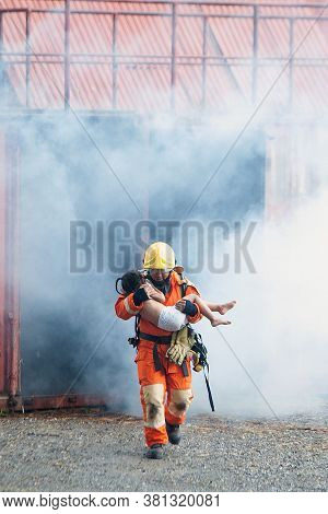 The Firefighter Was Helping The Girl. Leave The Burning And Smoky Building.