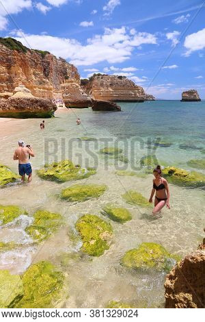 Algarve, Portugal - May 31, 2018: Beachgoers Visit Marinha Beach In Algarve Region, Portugal. Coasta