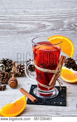 Christmas Mulled Wine With And Orange On Wooden Rustic Background. Selective Focus. Anise Stars And 