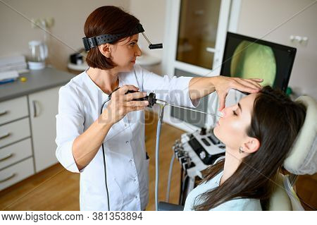 Female otolaryngologist and patient in office, exa