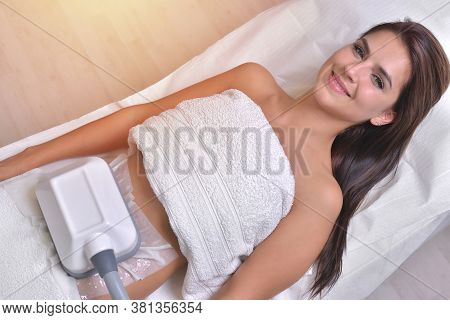 Beautiful Young Woman Getting Cryolipolyse Treatment In Cosmetic Cabinet