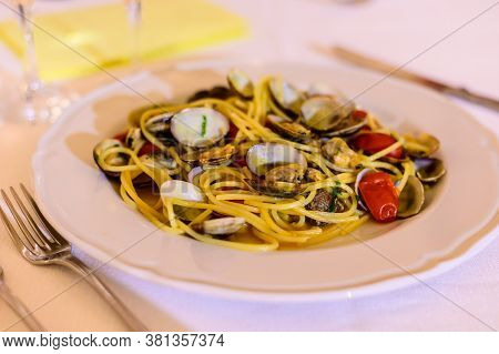 Frech Homemade Spaghetti Pasta With Vongole Sea Sheels And Small Red Tomatoes Close Up