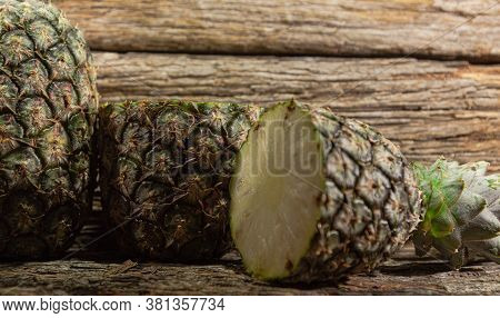 Halved Pineapple Fruit On Woody Background