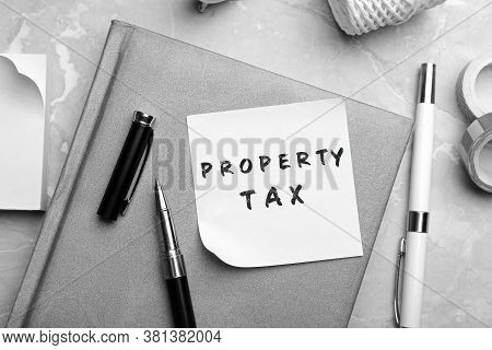 Note With Text Property Tax And Stationery On Table, Flat Lay